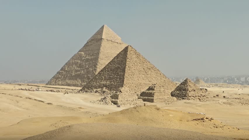 A panorama of the Giza Necropolis featuring the three principal pyramids built for Pharaohs Khufu, Khafre, and Menkaure, surrounded by the desert landscape.