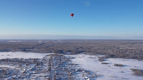 Drone Flying Upward toward Balloon over Winter