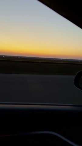 A beautiful sunset view from a moving car window