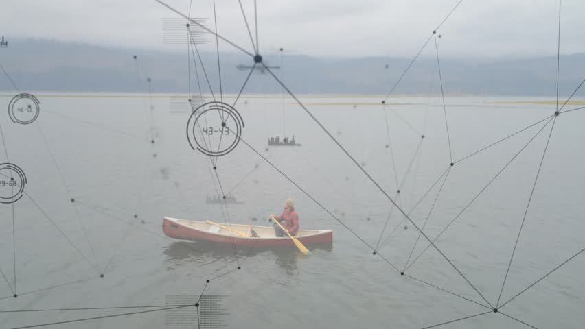 Male paddler taking right strokes steering canoe across lake, tech HUD nodes sweeping over canoe. Aerial, calm, water, solo, boater, overlay, graphics