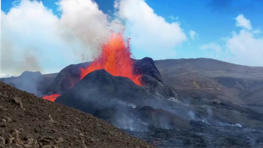 volcano eruption in land spewing lava and smoke