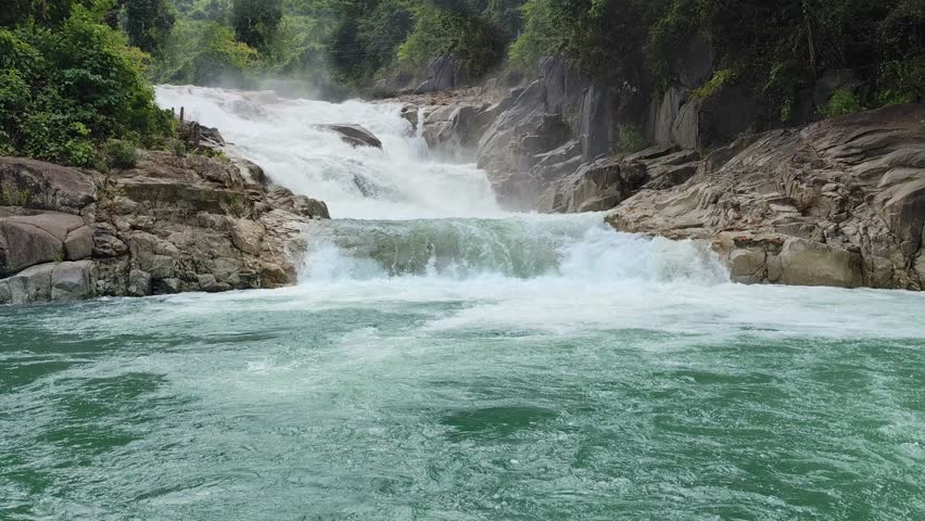 Beautiful waterfall in Yang Bay Park, Vietnam, surrounded by lush tropical greenery. Perfect for travel, tourism, Nha Trang, outdoor relaxation, and promoting Vietnam as a scenic destination.