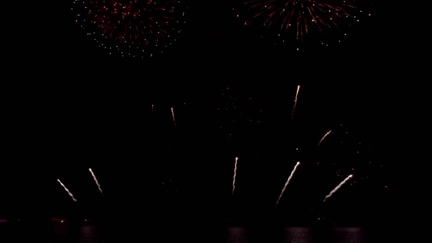 Amazing beautiful colorful firework display over sea on celebration night. Fireworks show for happy new year, 4k footage.	
