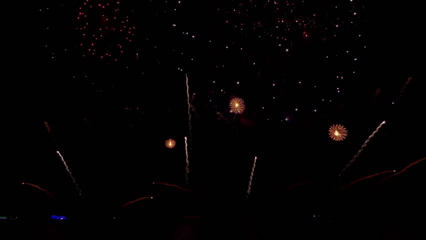 Amazing beautiful colorful firework display over sea on celebration night. Fireworks show for happy new year, 4k footage.	
