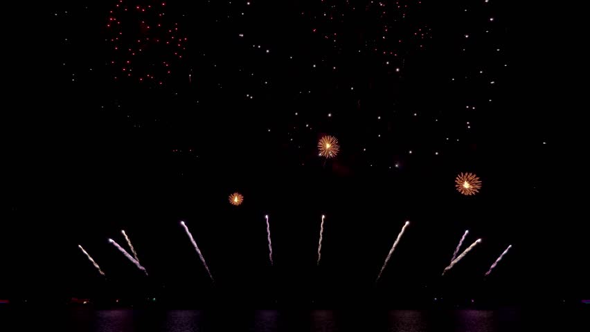 Amazing beautiful colorful firework display over sea on celebration night. Fireworks show for happy new year, 4k footage.	
