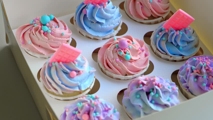 Colorful cupcakes with frosting and sprinkles perfect for festive celebration. Freshly baked cupcake box with creamy purple frosting. Decorated cakes. Sweet Dessert Preparation. Pastry small business