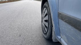 Detailed view of vehicle tire on wet asphalt during daytime - Powered by Shutterstock - Get 15% off with code: PIKWIZARD15