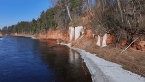 Sandstone cliffs with a icefall by the Salaca River in Latvia. - Powered by Shutterstock - Get 15% off with code: PIKWIZARD15