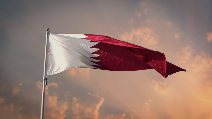 Qatar Flag At sunset sky 