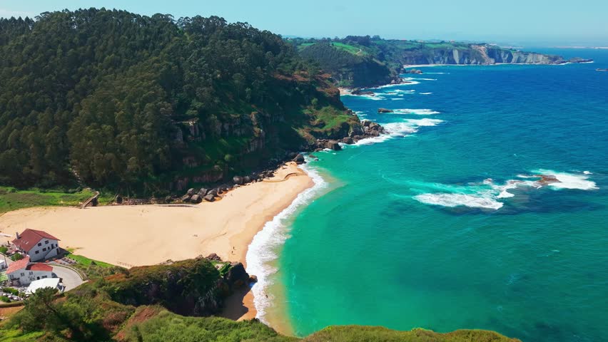 Amazing Playa de La Nora beach near Gijon, Asturias, northern Spain. Aerial view of the idyllic white sand beach with turquoise sea water along the Cantabrian Sea coast of Asturias.
