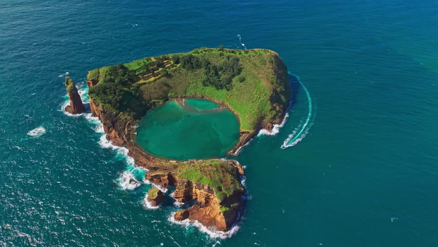 Aerial view of Islet of Vila Franca do Campo at Sao Miguel Island, Azores, Portugal, featuring a small heart shape island with a turquoise lagoon, scenic coastline, and natural landscape.