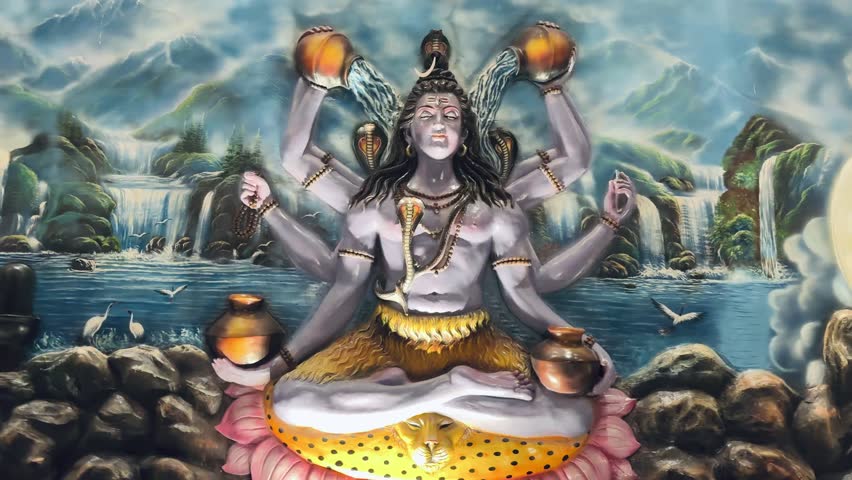 statue of Lord Shiva with multiple arms, symbolizing cosmic control, universal power, and divine protection. The dramatic pose and illuminated background enhance the sculpture’s grandeur.