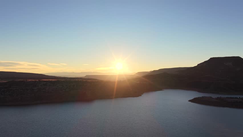 Smooth lateral drift over the water, concluding at the shoreline of Abiquiu Lake. This high desert reservoir is a key feature in the New Mexico landscape of Georgia O