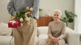 Senior man giving flowers gift box to old woman. Happy family couple. Husband wife with present tulip flowers bouquet celebrating women day birthday family wedding date Valentines day. In love people - Powered by Shutterstock - Get 15% off with code: PIKWIZARD15