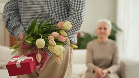 Senior man giving flowers gift box to old woman. Happy family couple. Husband wife with present tulip flowers bouquet celebrating women day birthday family wedding date Valentines day. In love people - Powered by Shutterstock - Get 15% off with code: PIKWIZARD15