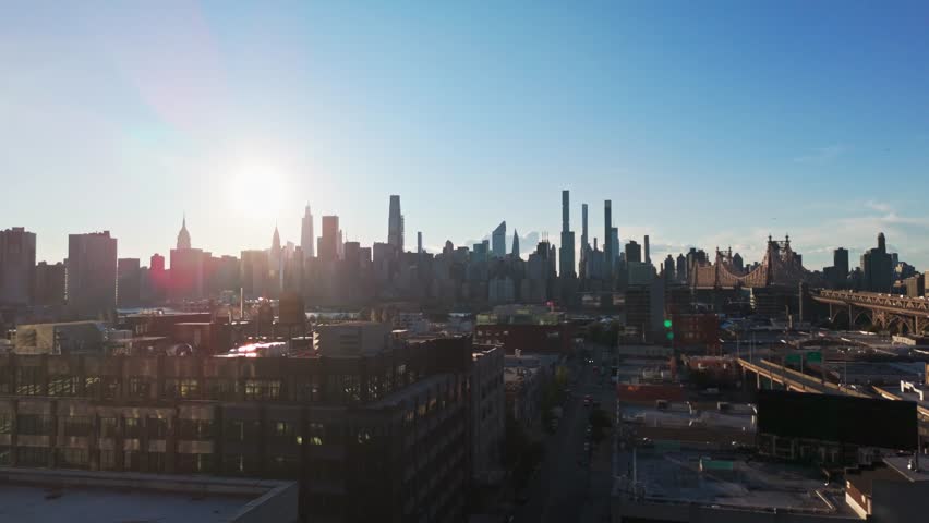 Rising drone shot of Midtown Manhattan and Queensboro bridge during daytime