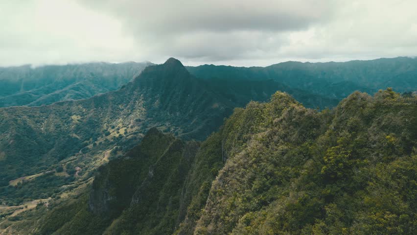 Aerial Hawaii Lush Ridgeline Panorama With Layered Peaks And Verdant Valleys, Mist Clinging To Slopes And Native Shrubland