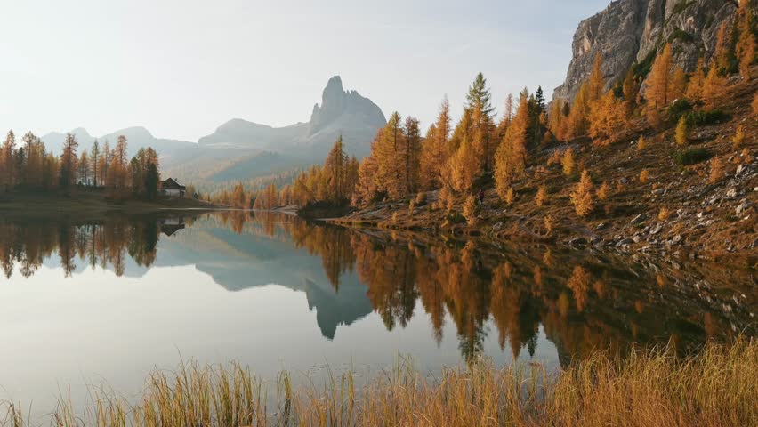 Crystal clear water. Lake Federa near the Croda da Lago mountain at autumn time, majestic landscape, raw nature