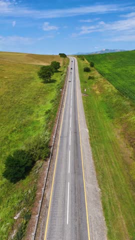 a road in the countryside among green hills