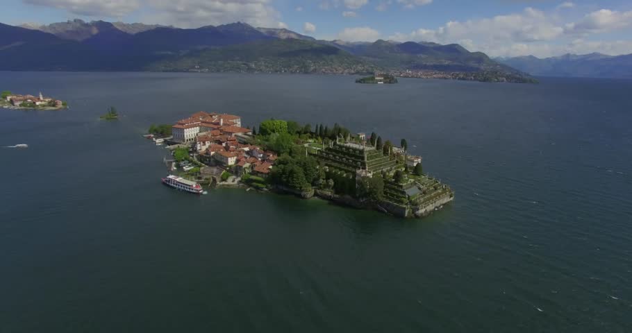 Expansive drone panorama of the complete Isola Bella island on Lake Maggiore, Italy, featuring the Palazzo Borromeo, extensive baroque tiered gardens