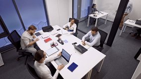 Business coworkers are engaged in a productive meeting, discussing strategies and analyzing data on laptops and documents. The team collaborates efficiently in a modern office environment. - Powered by Shutterstock - Get 15% off with code: PIKWIZARD15