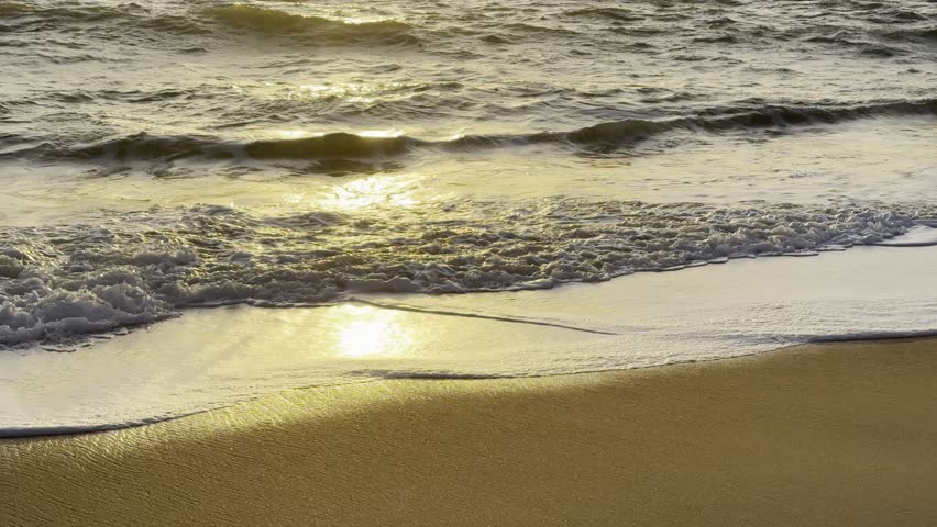 Golden Sunset over the Ocean with Rocks on the Beach