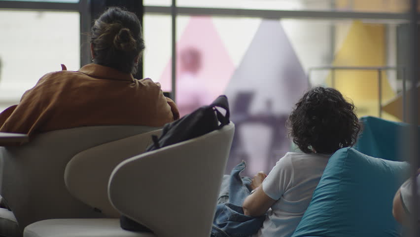 Footage of audience members attending talks at a tech event, listening, taking notes, and watching presentations. Ideal for conference promos and educational or business video projects.