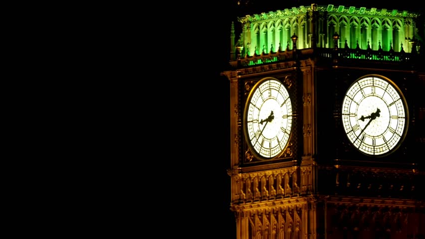 Illumination of Big Ben highlights intricate design of clock tower. Nighttime display features vibrant green lights casting an enchanting glow over landmark. Captivating atmosphere in London.