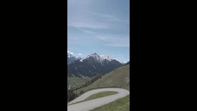 Neustift, Austria - April 19, 2025 - vertical scenic view of snow-capped mountains and a winding road on a sunny day - Powered by Shutterstock - Get 15% off with code: PIKWIZARD15