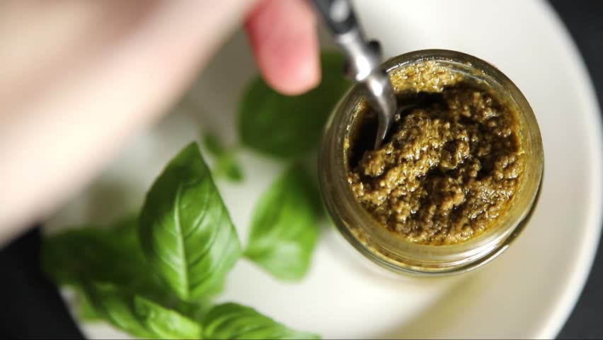 Pesto sauce green basil, olive oil, parmesan, pine nuts, garlic natural tasty snack fresh gourmet food background on the table rustic top view copy space