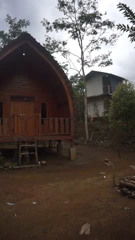 Rustic wooden cottage located in a natural forest environment, offering a serene and eco-friendly retreat.