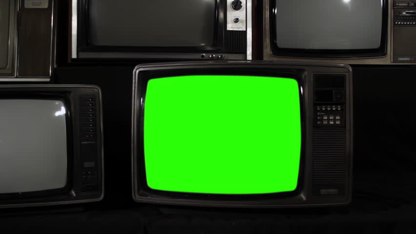 Retro TV With Color Bars Flicker Turning On, Then Green Screen, Surrounded by Old Televisions, Zoom Out - 4K