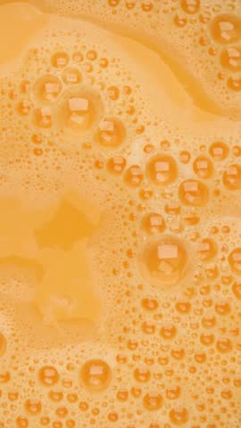 foamy beaten egg mixture, rotation in circle. whisked eggs for cooking preparation, Turning. vertical video. natural cooking ingredient. Hollandaise sauces
