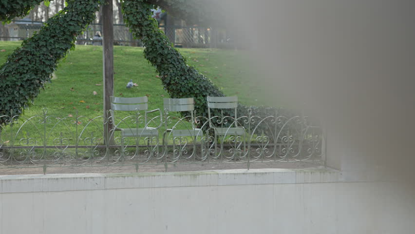 Three Green Chairs in Focus Inside Peaceful Parc du Luxembourg Paris France
