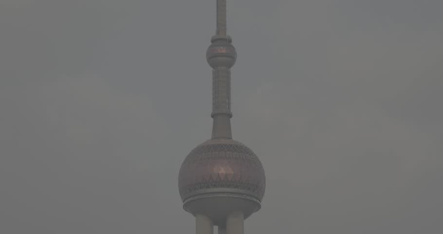 Shanghai, China. Oriental Pearl Tower rises alongside remarkable modern buildings. copy space time lapse.