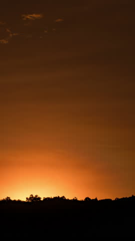 Beautiful sunrise time-lapse over the mountains with soft morning light and moving clouds.