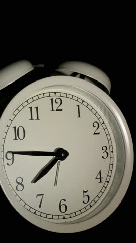 Tme lapse video of a clock time passing over a day to night on black background.