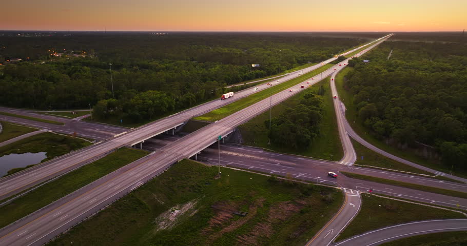 Elevated view of freeway junction near North Port, Florida with trucks and cars rapidly moving along I-75 highway
