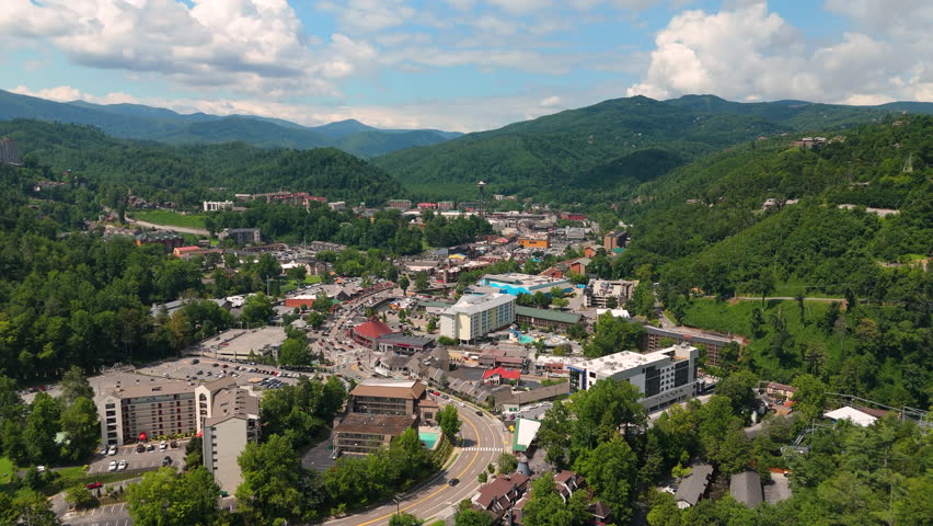 Gatlinburg, Tennessee city tourist area with busy streets and scenic mountain backdrop.