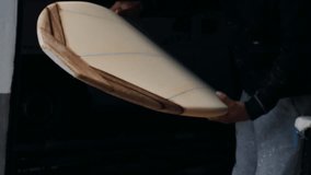 Expert surfboard shaping techniques demonstrated by skilled shaper in workshop - Powered by Shutterstock - Get 15% off with code: PIKWIZARD15