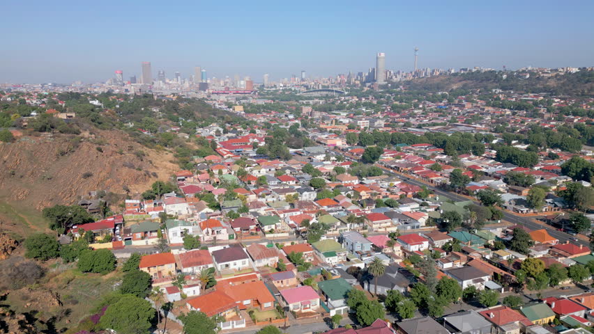 Cityscape of Johannesburg city and Hillbrow from the hills and suburbs of Kensington during morning.