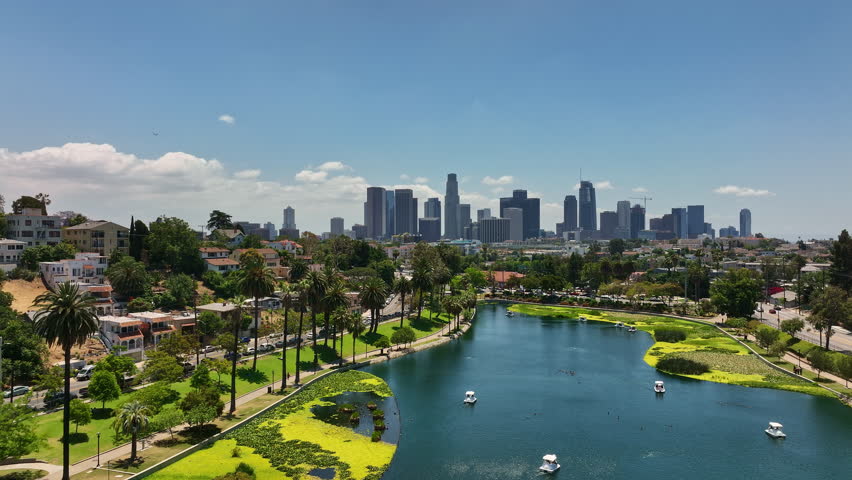 Downtown Los Angeles from drone above Echo Park. Los Angeles skyline from Echo Park side. City of LA overlooking Echo Park. Aerial flight above downtown LA and Echo Park.