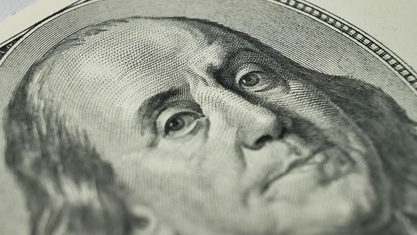 100 dollar bill, focusing on Benjamin Franklin portrait. Deposit money used in banking and financial systems. Currency used as medium of exchange in domestic and international markets