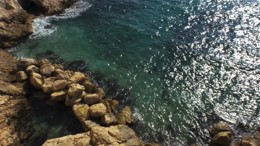 Marseille unfolds with shimmering waves, rugged hills, and its iconic corniche