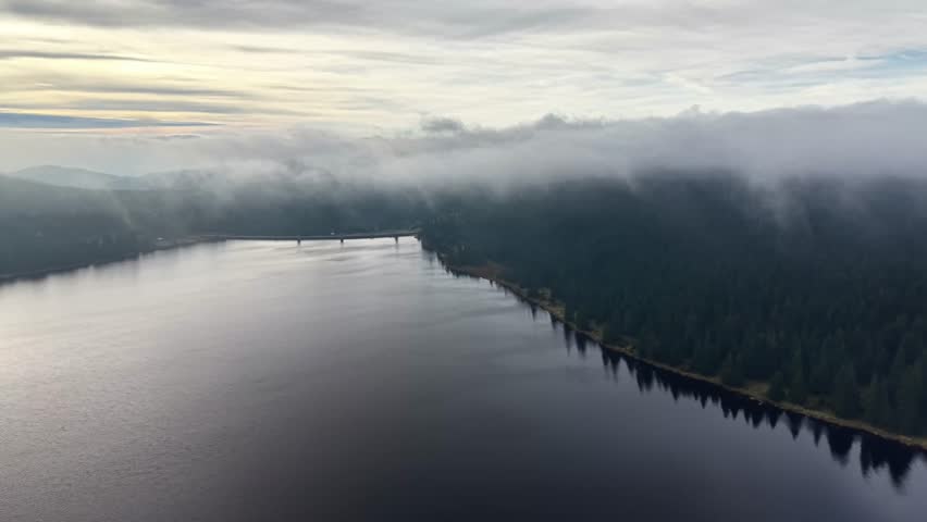 morning light unveils distant horizon, cinematic shot reveals calm water and shoreline emergence