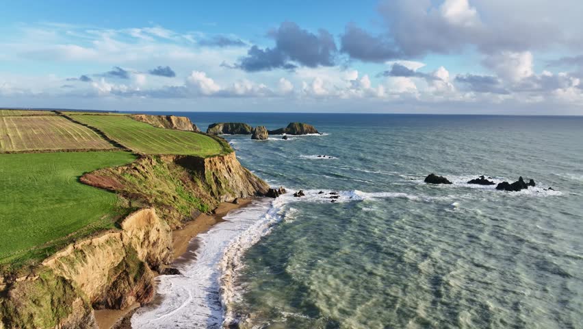 Ireland epic Coastline Atlantic winter storm waves on beach fragile sea cliffs prone to erosion Copper Coast Waterford