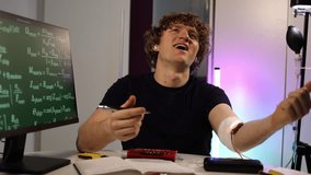 Student writes down results from his self run scientific experiment while sitting at the desk with tools and monitoring devices creating a focused moment of documenting personal research work - Powered by Shutterstock - Get 15% off with code: PIKWIZARD15