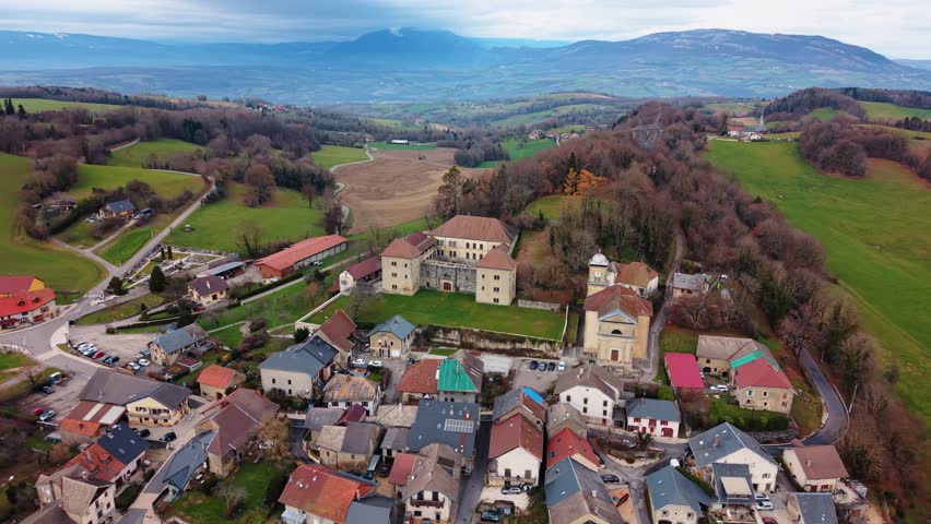 Aerial view of Chateau de Clermont, buildings and mountain, France.