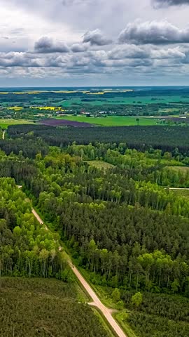 Hyperlapse Of Stormy Clouds Sky Over Green Countryside Landscape - Vertical Shot