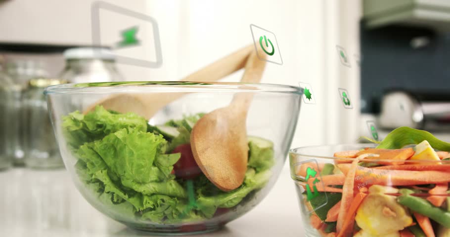 Icons appearing from right floating around two glass salad bowls, depicting green energy recycling. Vegetables, lettuce, carrots, kitchen, highkey, bright, parallax